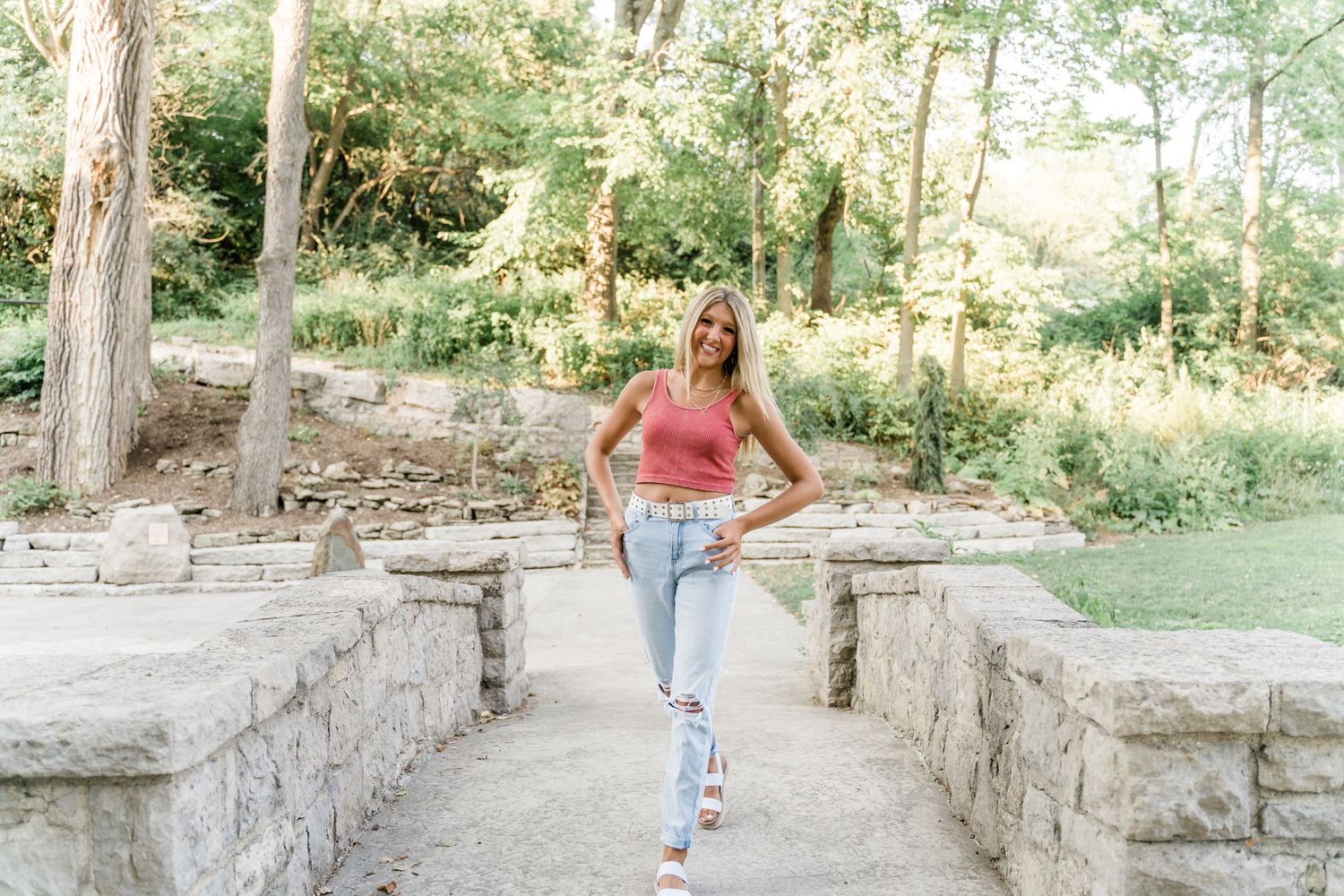 Fun summer senior session at Side Cut with Springfield High School senior in muted pink and jeans on the bridge.