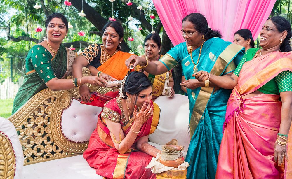 Festive traditional Indian ceremony with colorfully dressed attendees playing drums and celebrating.