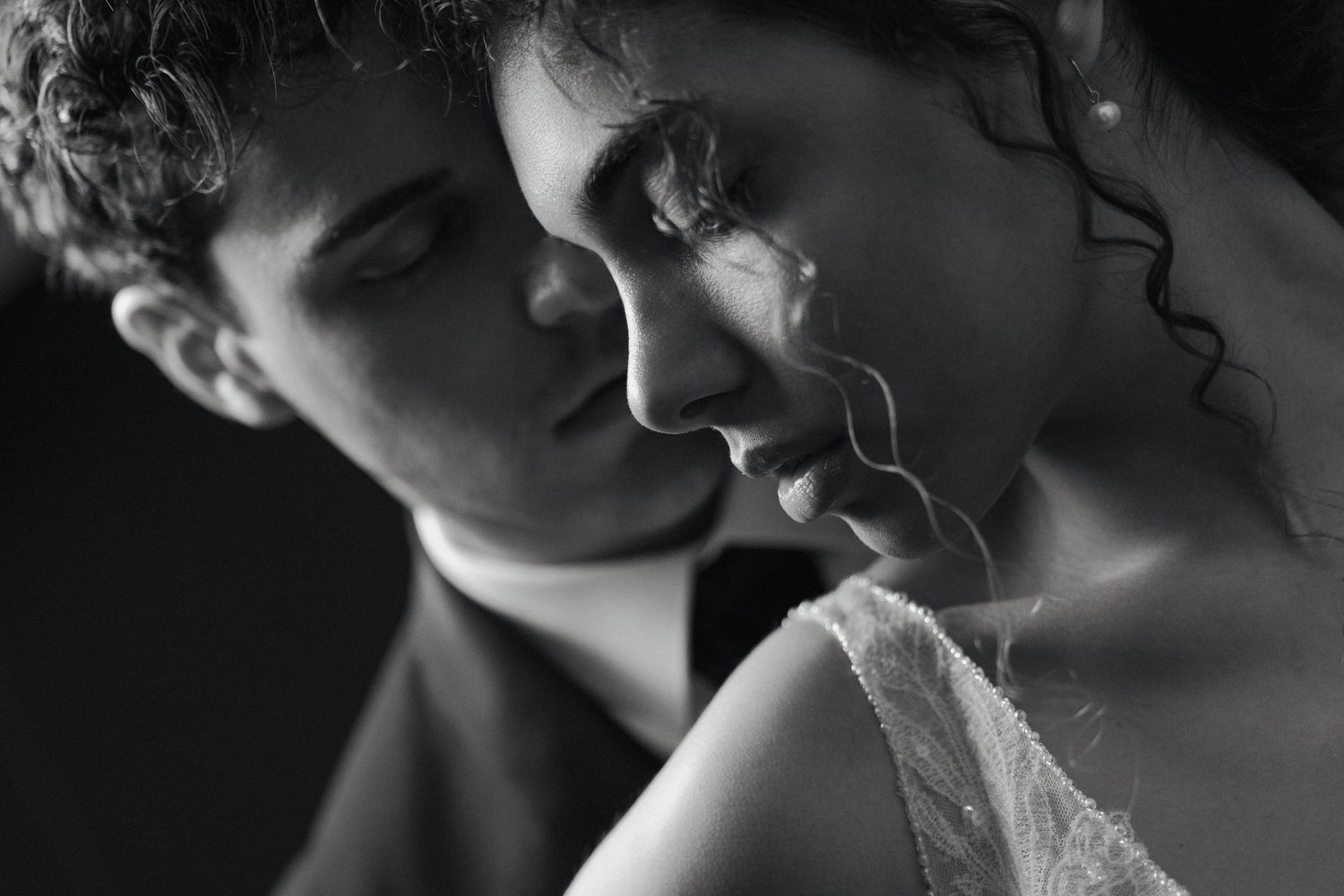 Black and white artistic close-up portrait of an intimate moment.