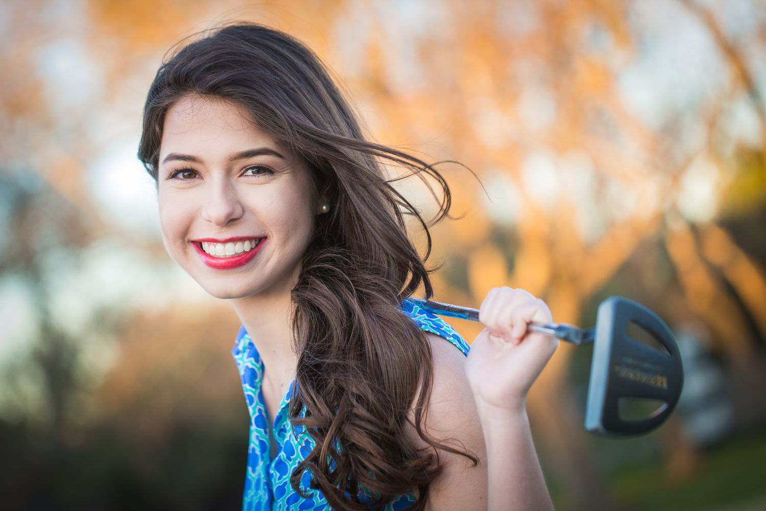 Portrait session in autumn setting with warm golden lighting.