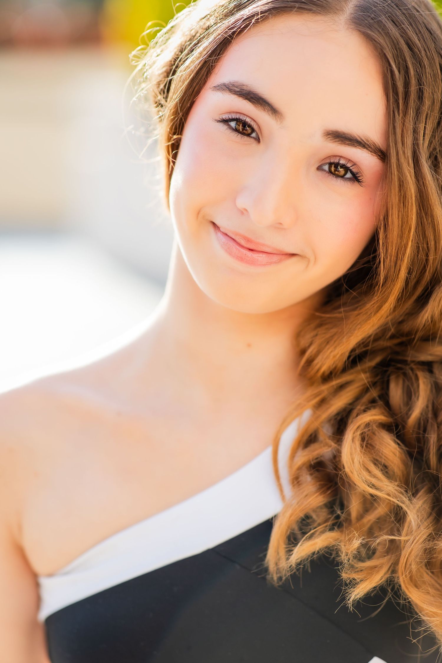 Close up portrait with natural makeup and black and white asymmetrical top.
