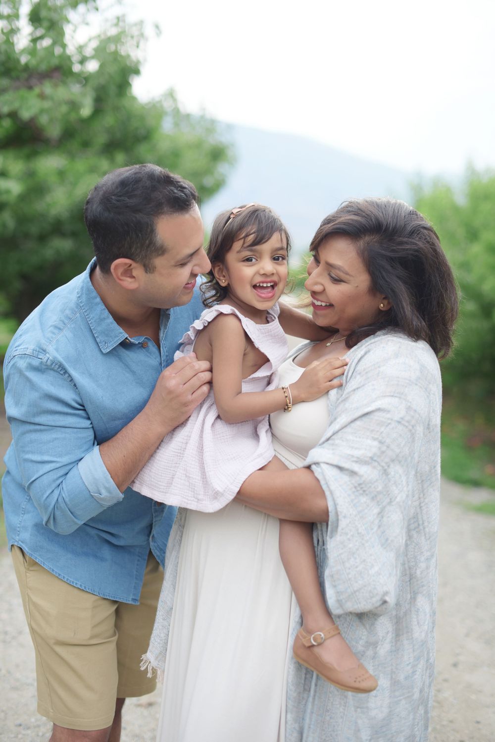Joyful family moment captured outdoors with casual spring attire in Osoyoos, B.C.