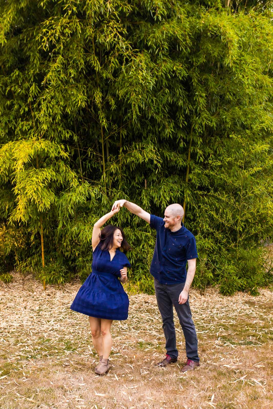 Candid photo of husband and wife twirling and dancing