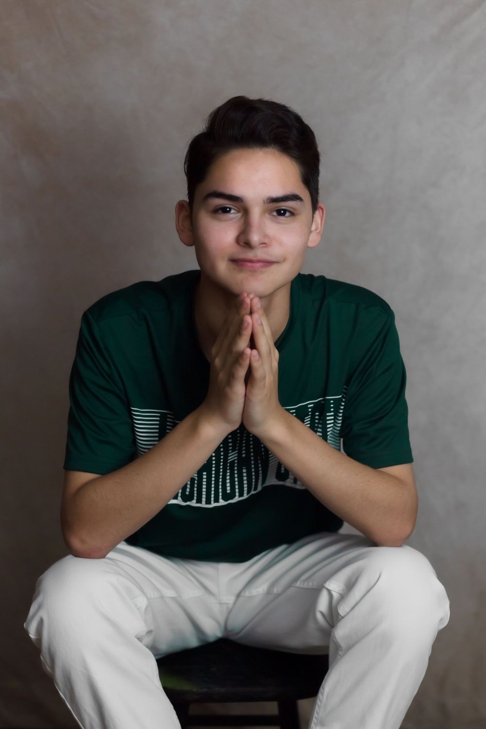 high-school-senior-guy-sitting-on-a-stool-Shepherd-Michigan