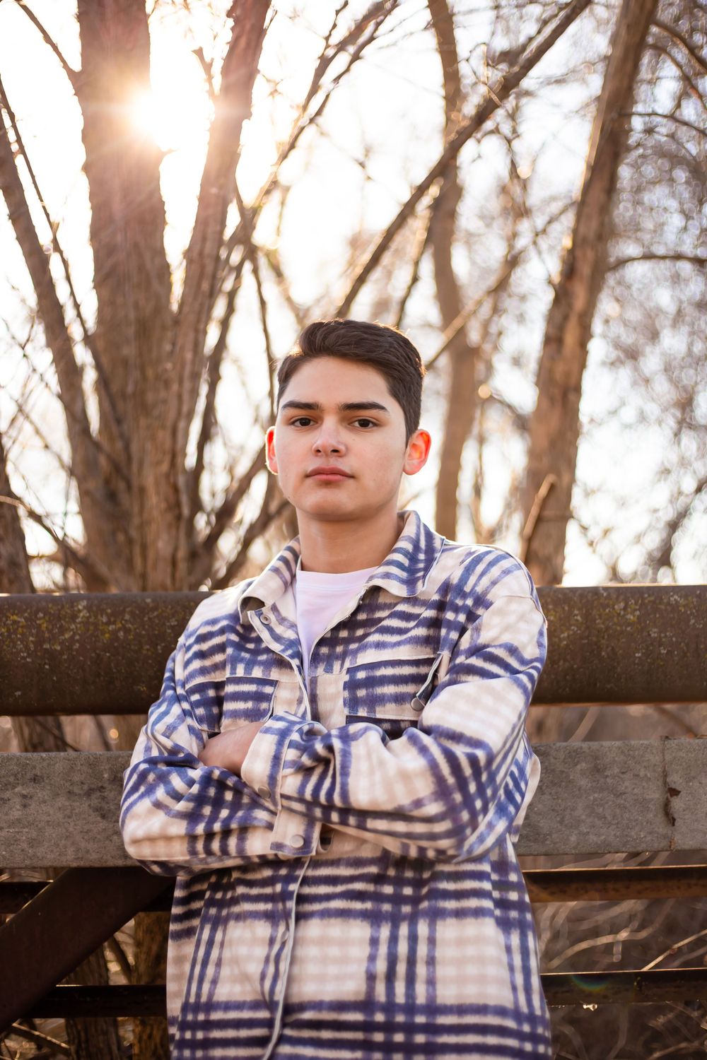 Male High School Senior with sun behind them