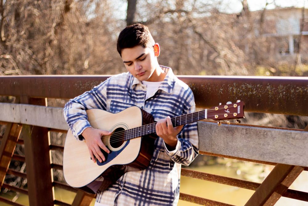 Male Senior Photo holding a guitar