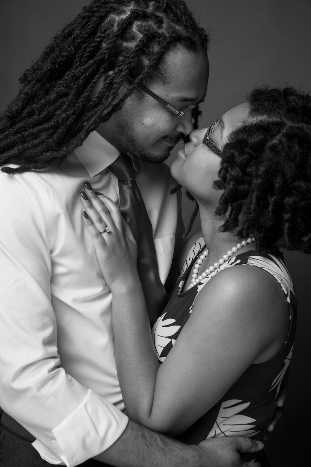 Intimate black and white portrait of a couple in a tender moment.