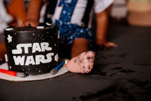 Close-up detail of a black Star Wars themed birthday cake.