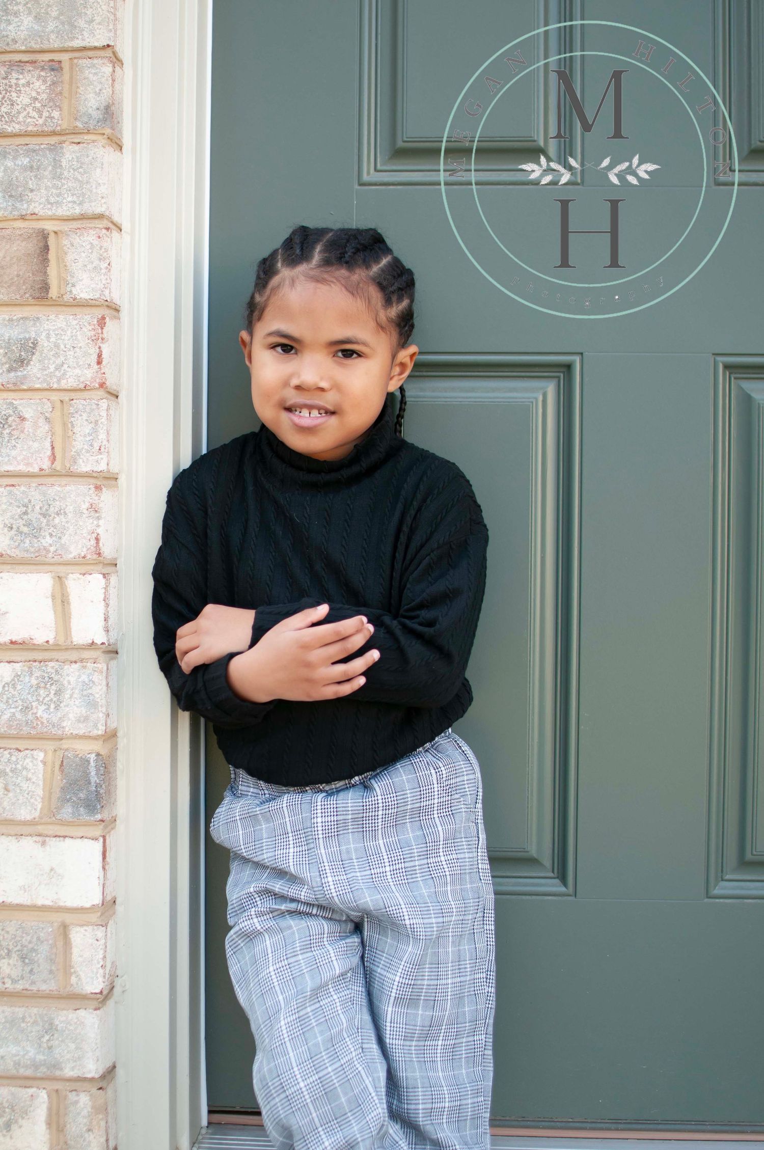 Four year old boy standing by door