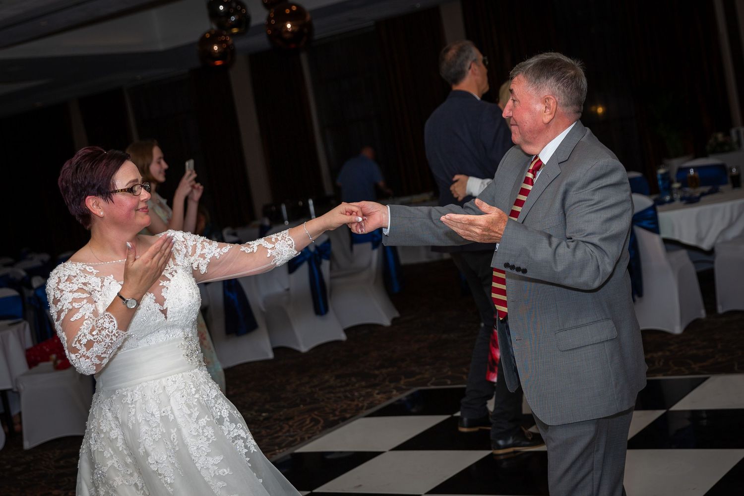 Bride dances with a Male wedding guest at the Crown Plaza Hotel. Liverpool city centre wedding photographer