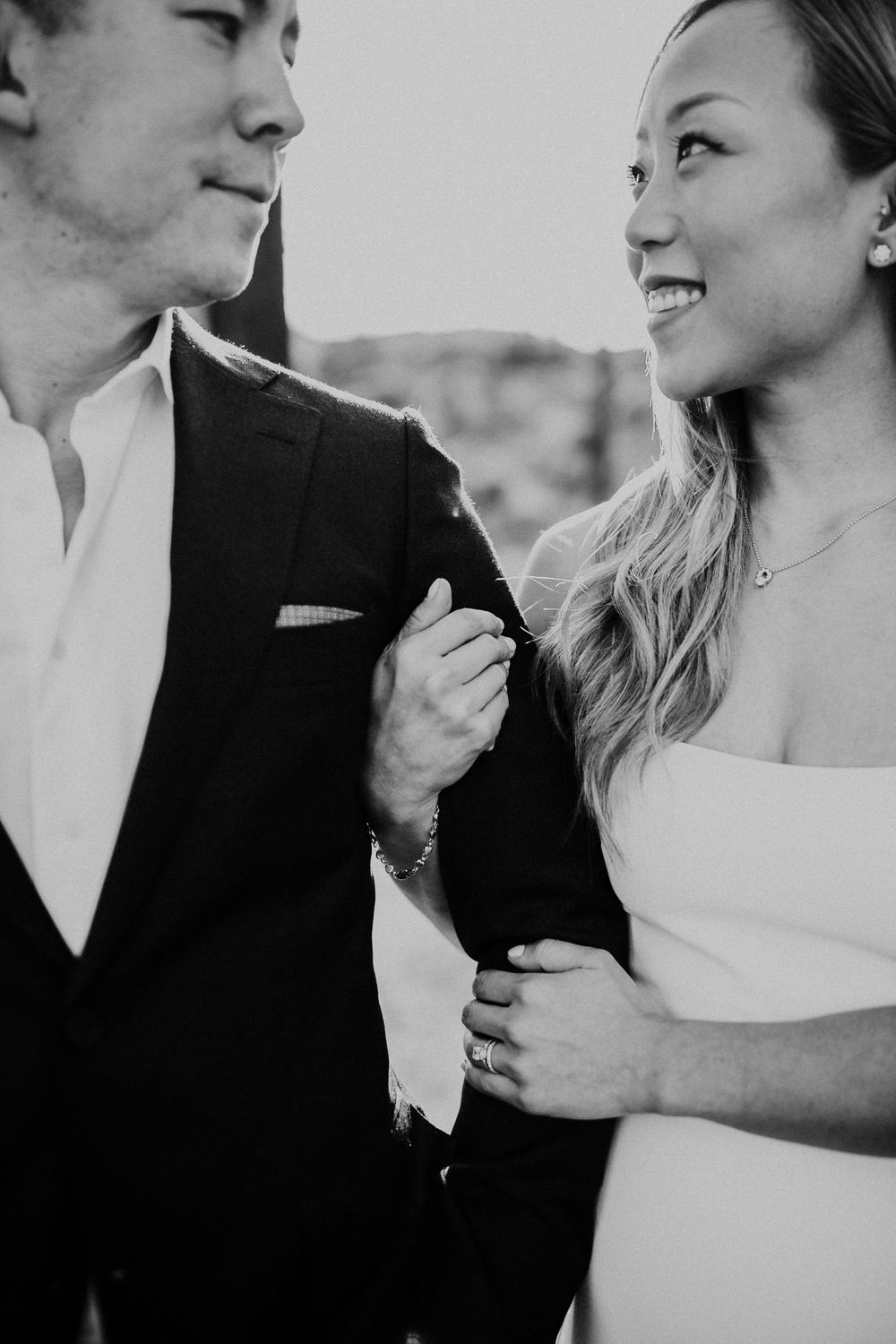 Black and white candid portrait of a happy couple sharing an intimate moment.