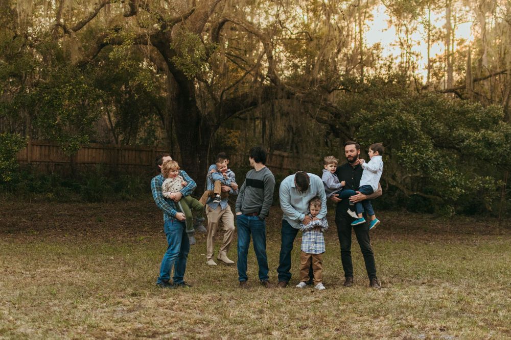 Group gathering in an autumn field during golden hour.