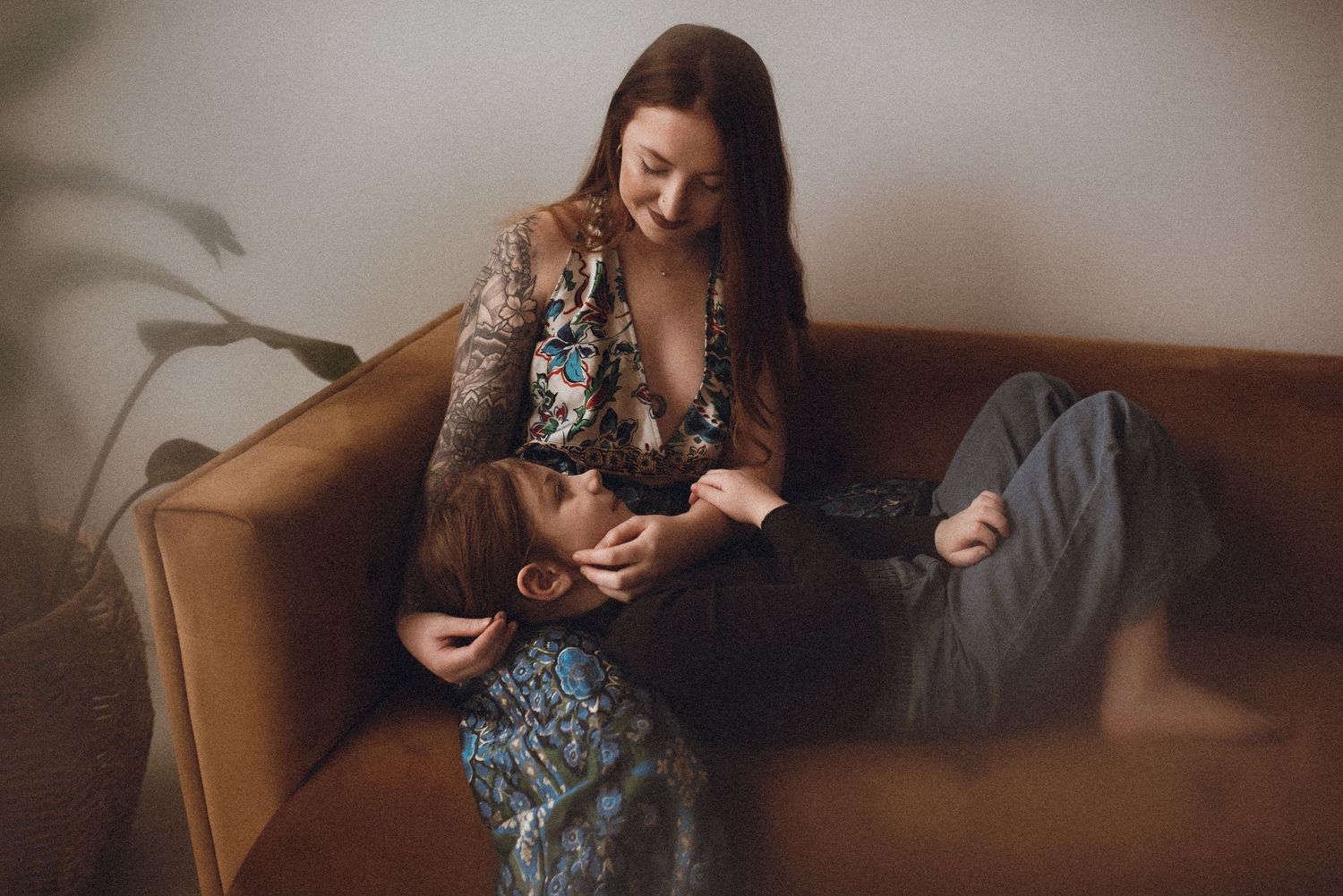 A relaxed lifestyle photography session taking place on a comfortable brown leather couch.