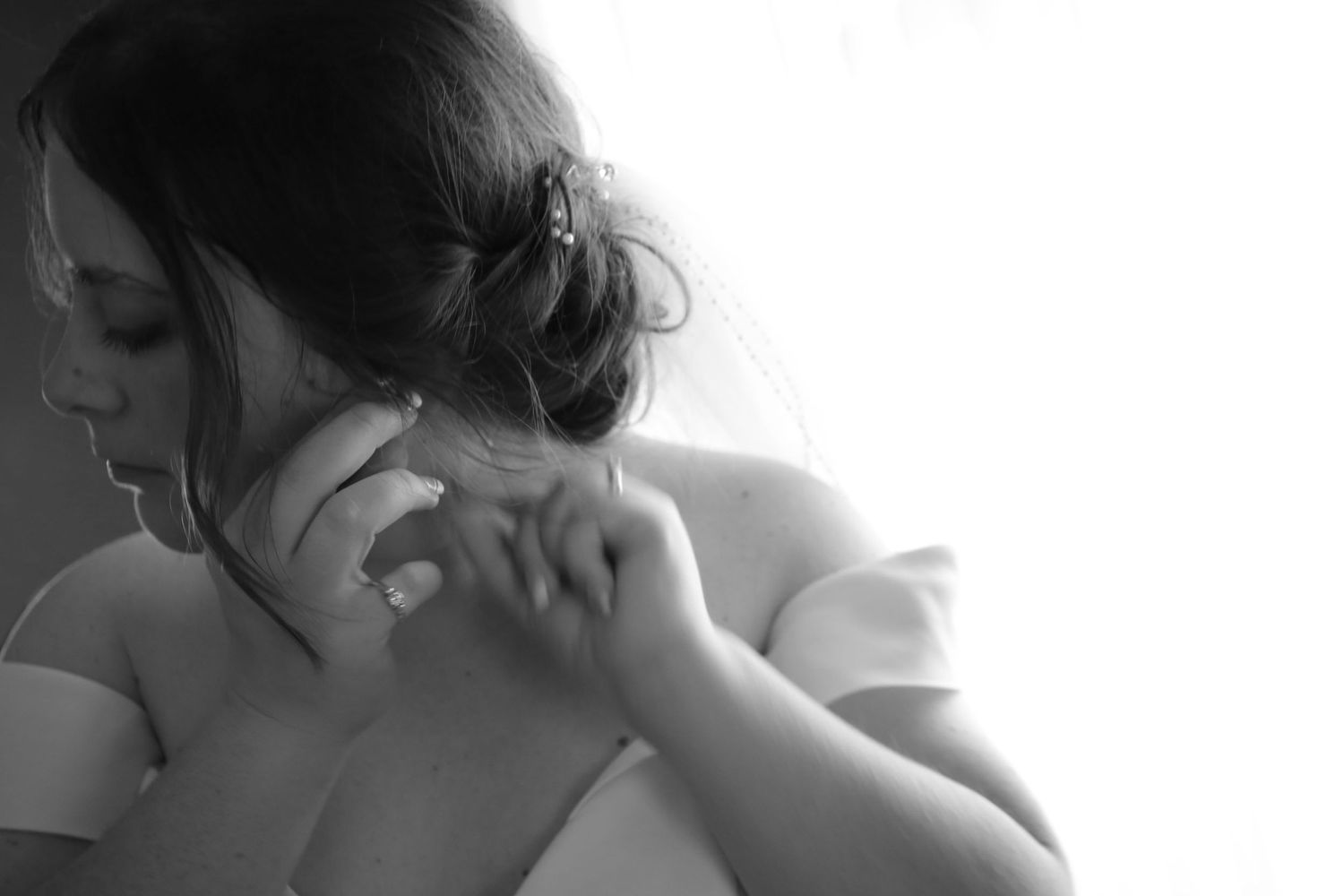 bride putting on earrings