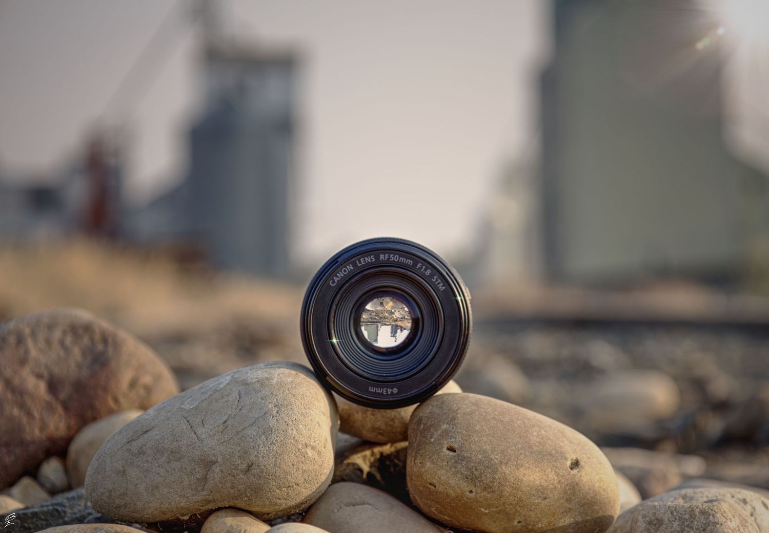 camera lens siting on rocks