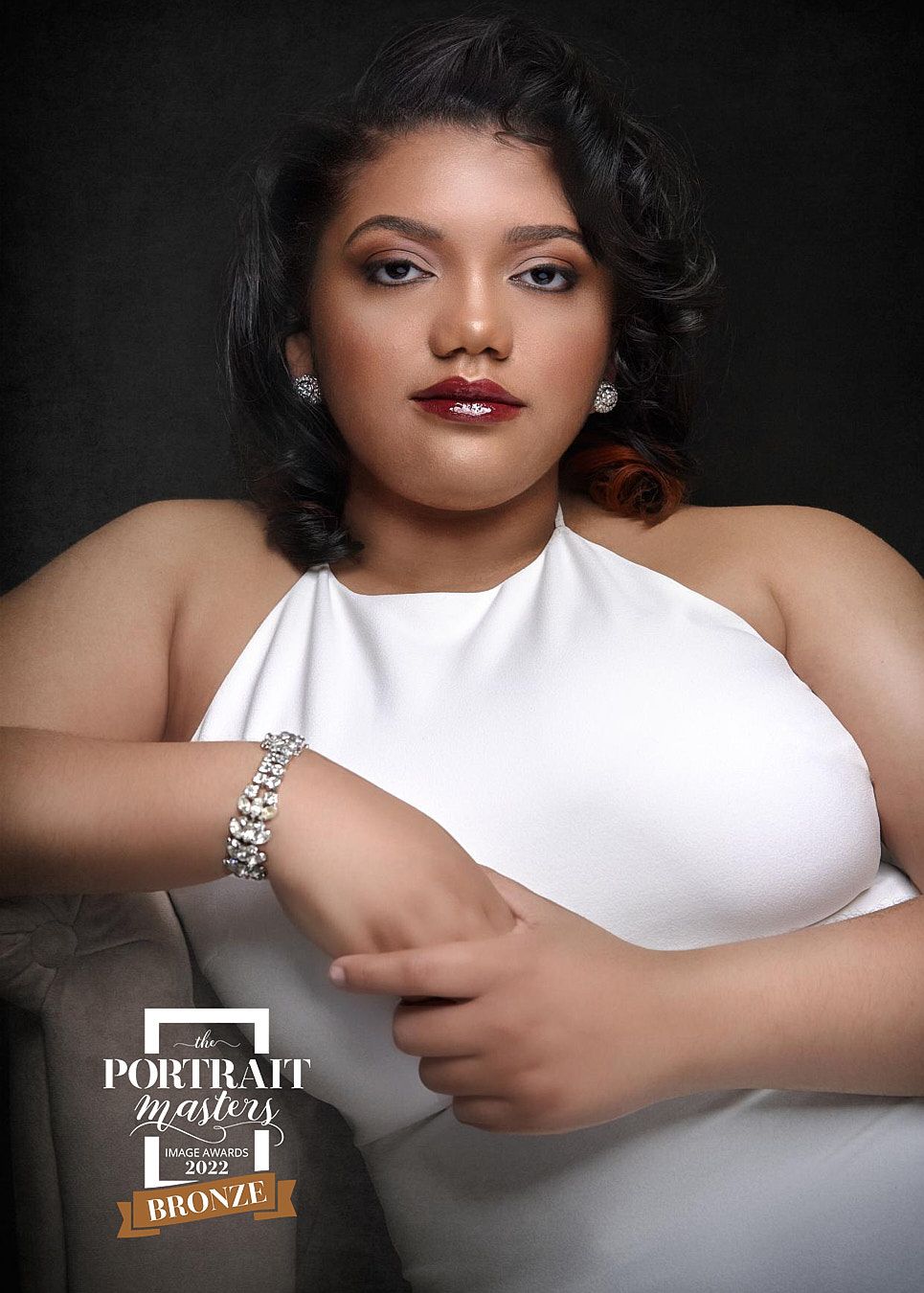 Woman in white halter dress with diamond jewelry, Portrait Masters 2022 Bronze award portrait.