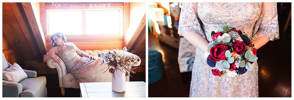 Bride in silver lace gown holding vibrant red and navy floral bouquet in rustic setting.