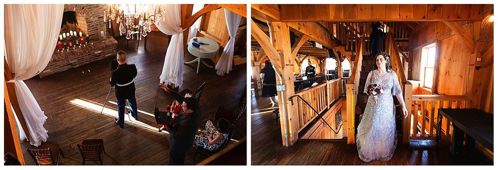Bride in silver gown descends staircase in rustic barn wedding venue with wooden beams and draped fabric.