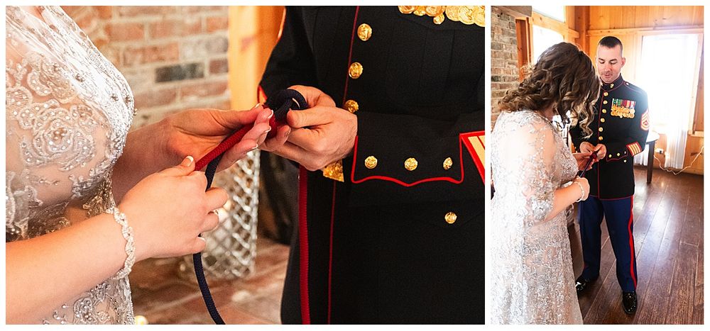 Bride and Marine groom exchange wedding rings during intimate rustic barn ceremony.