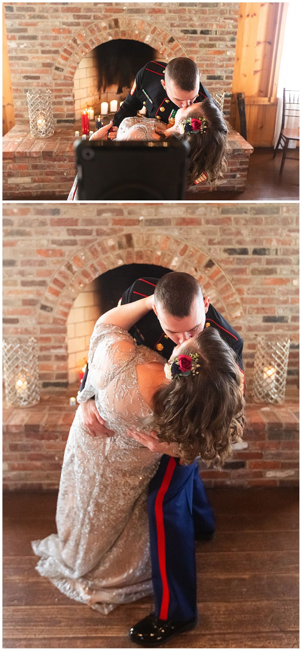 Marine groom dips bride for romantic kiss in front of candlelit brick fireplace after wedding ceremony.