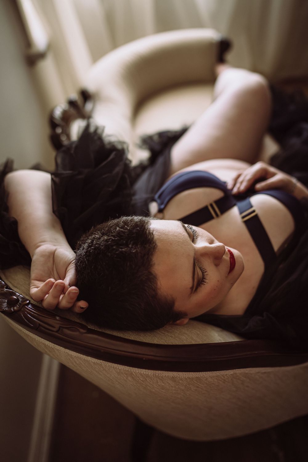 plus size woman in sexy lingerie posed on chaise lounge