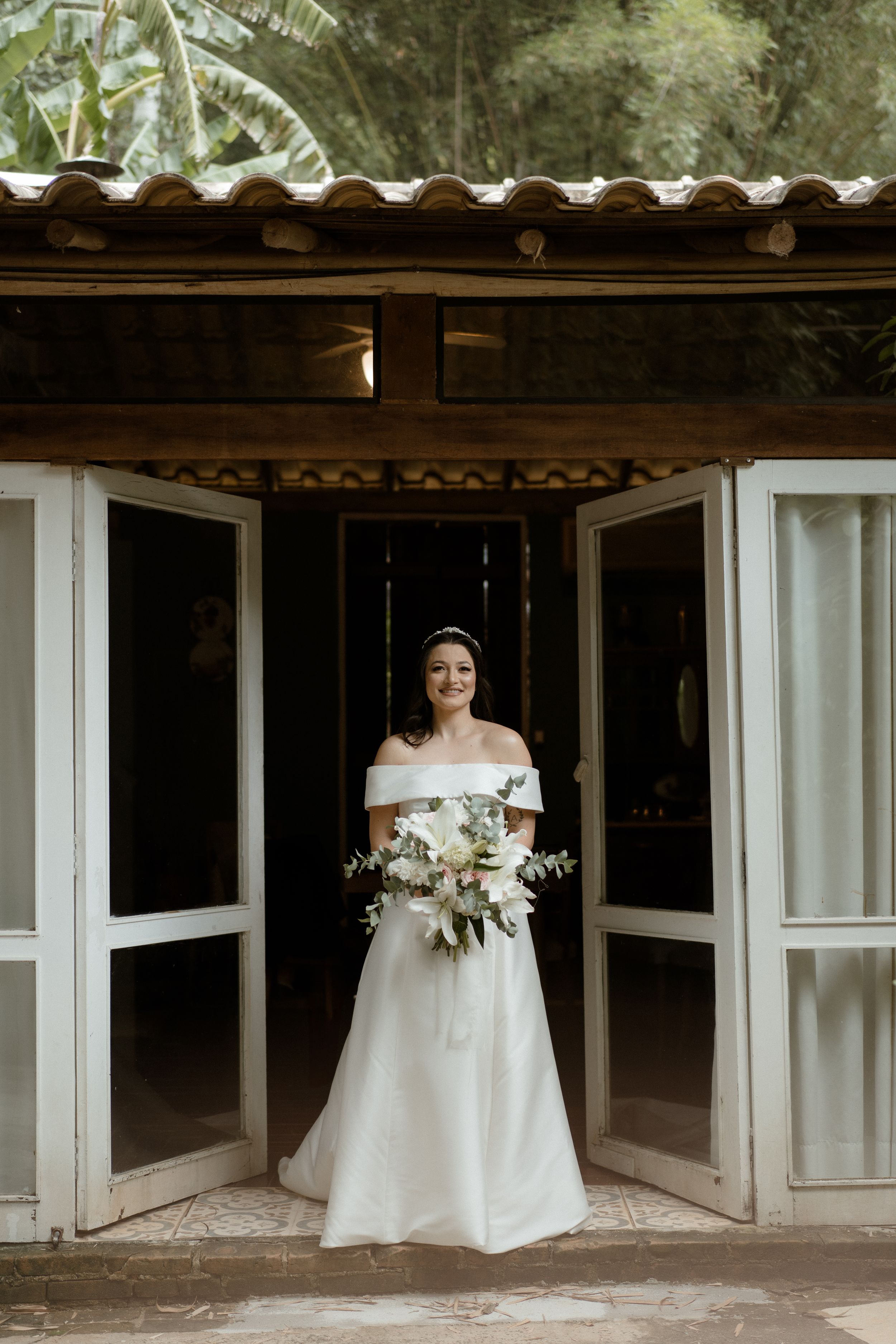 Architectural wedding venue with white doors and rustic design elements.