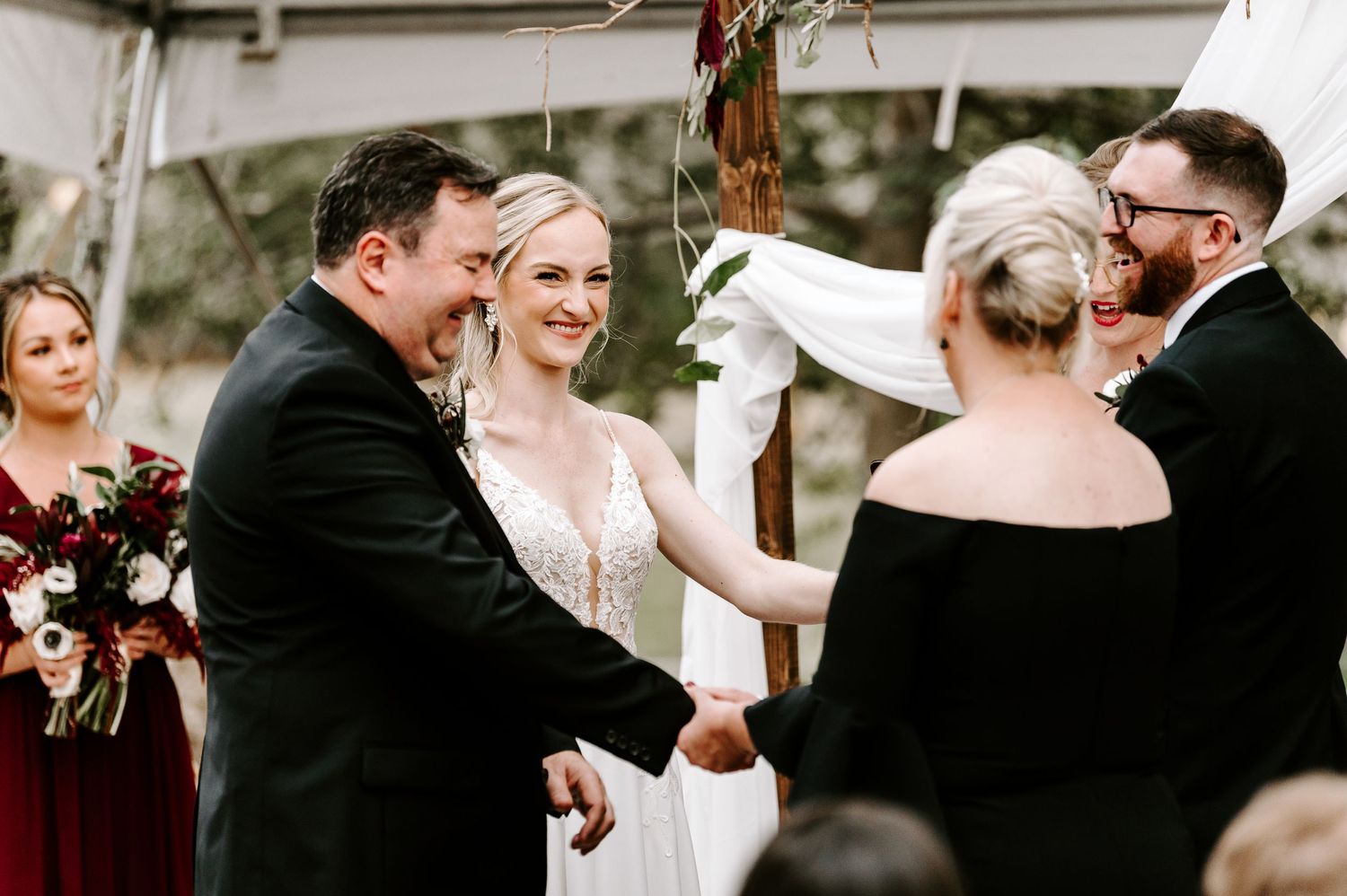 Candid moments captured during wedding ceremony under clear tent with guests.