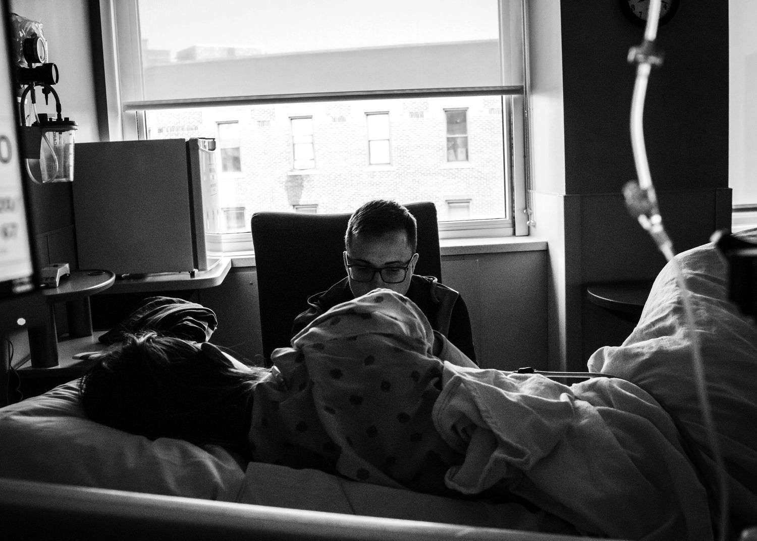 Dad to be supporting his amazing wife while she labors and they wait for their baby to be born in Sioux City, IA.