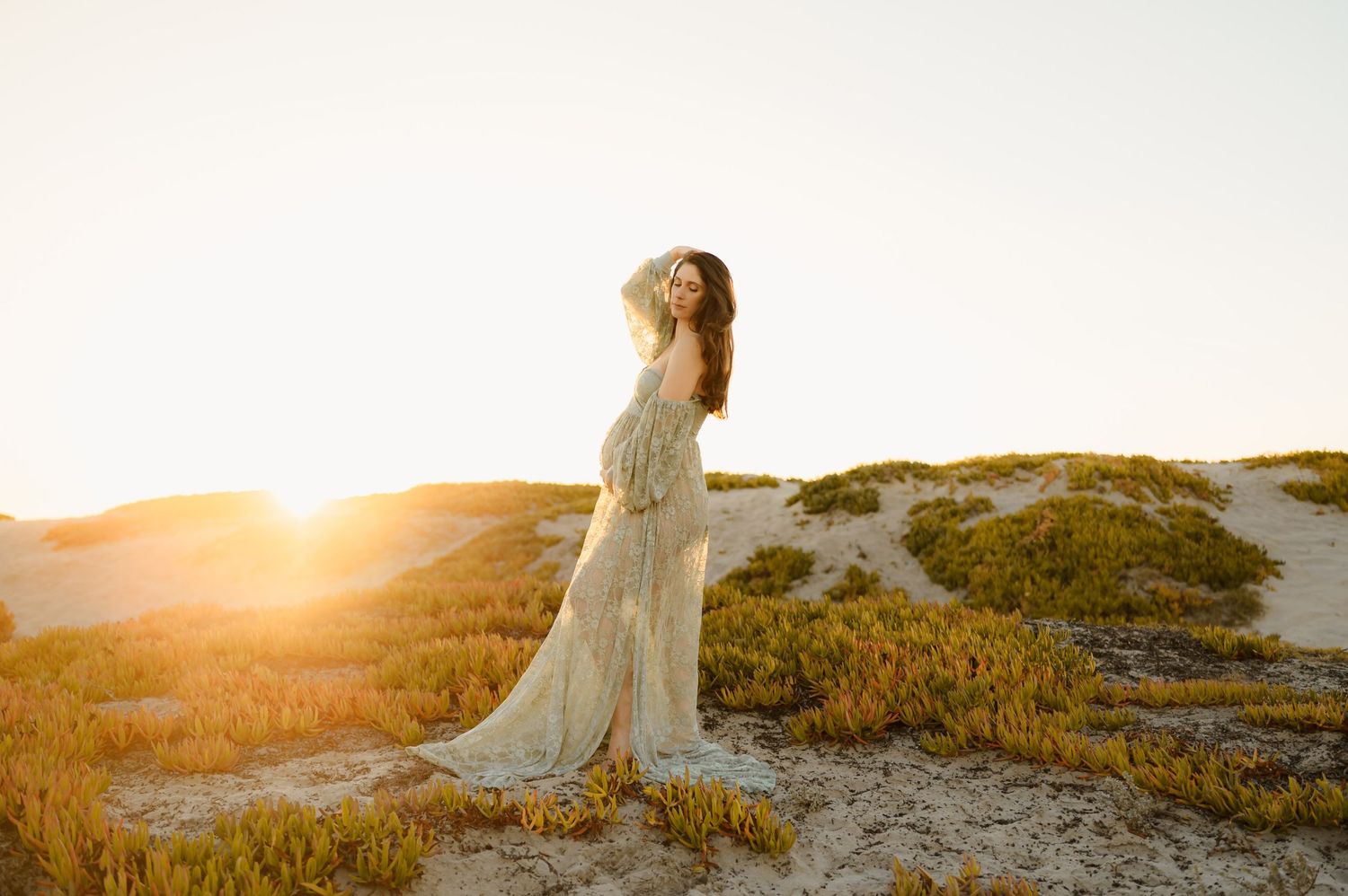 Ventura sunset maternity photoshoot by Santa Barbara and Ventura photographer Tiffany Kelterer, of pregnant woman posed in sand dunes