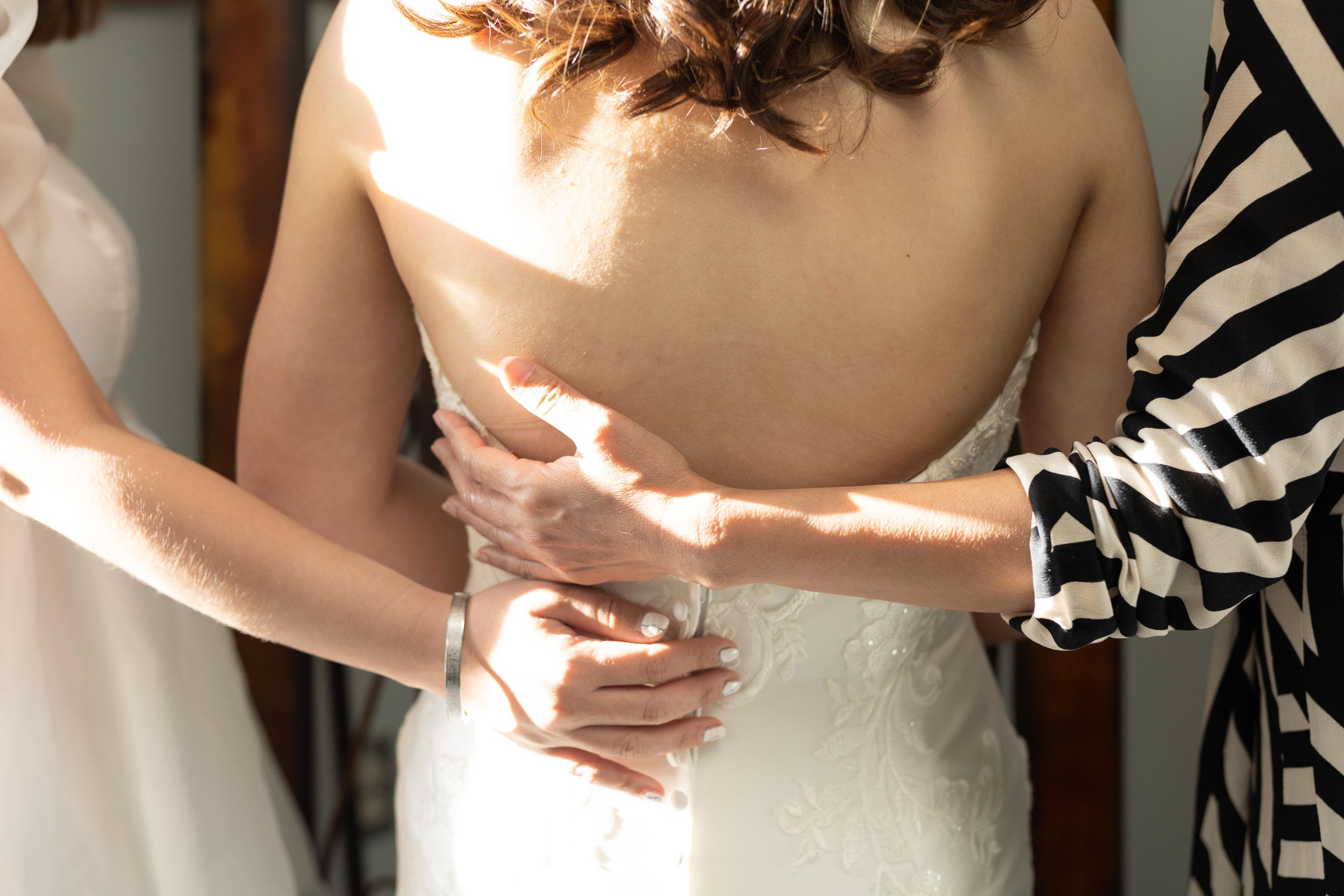 Close-up details of elegant white bridal dress.