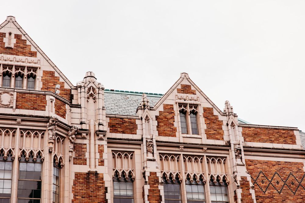 Gothic revival architecture details of a brick university building with ornate windows and peaks.