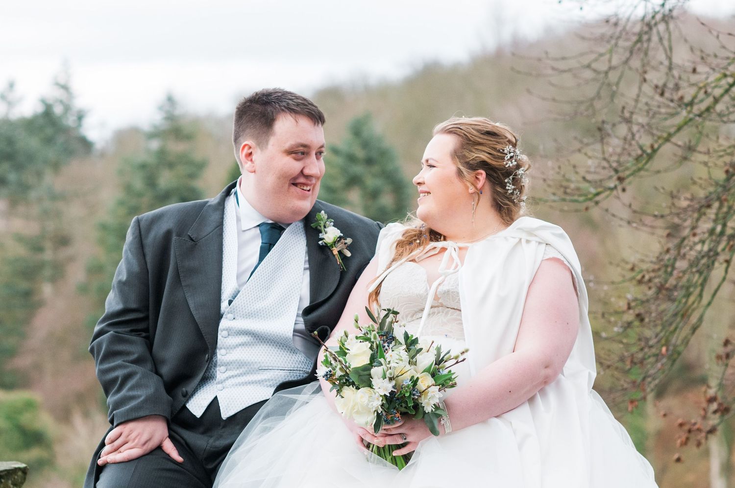 Bride and groom gaze at each other in the winter light after their Askham Hall Wedding