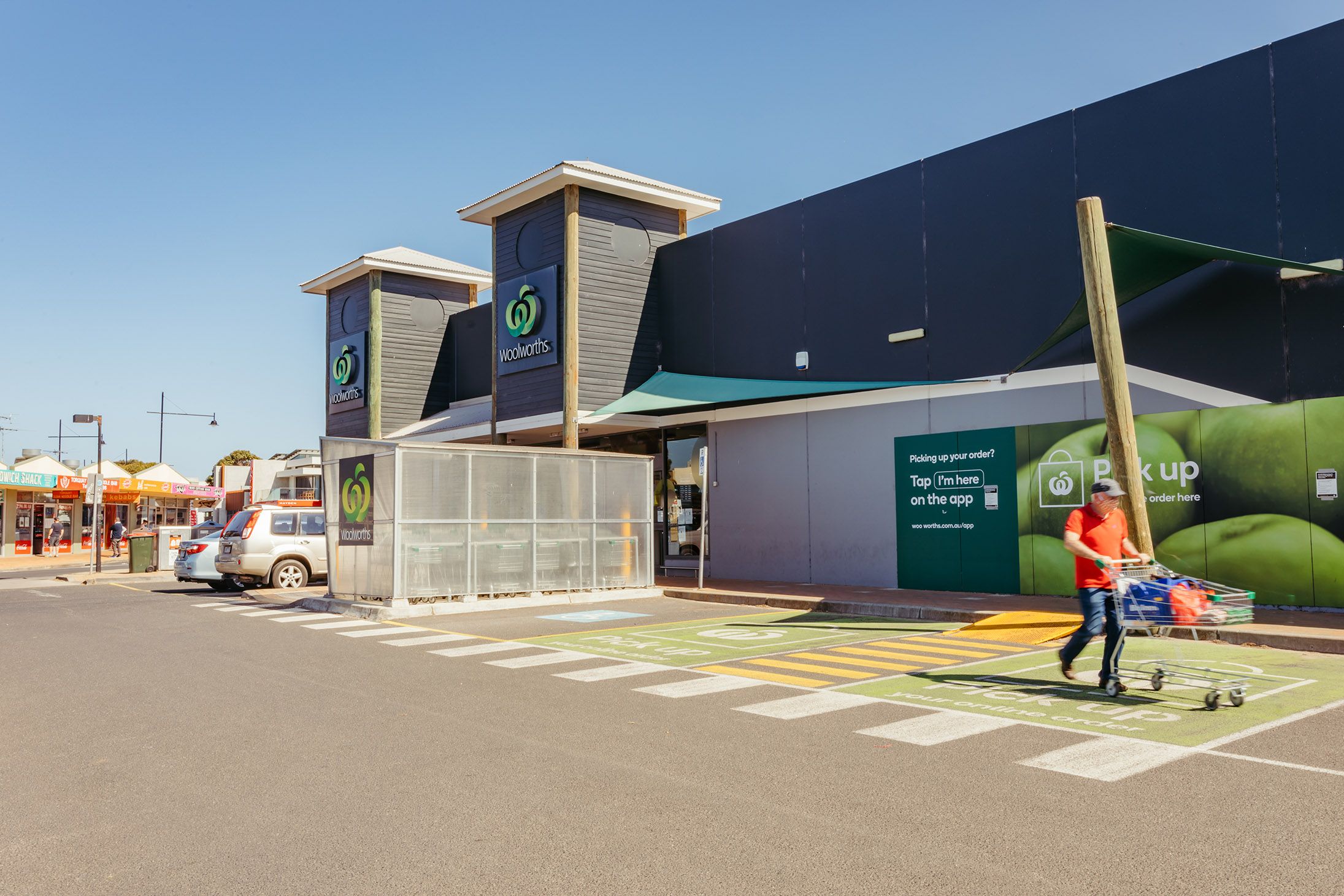 Exterior view of modern retail storefront with glass windows and entryway.