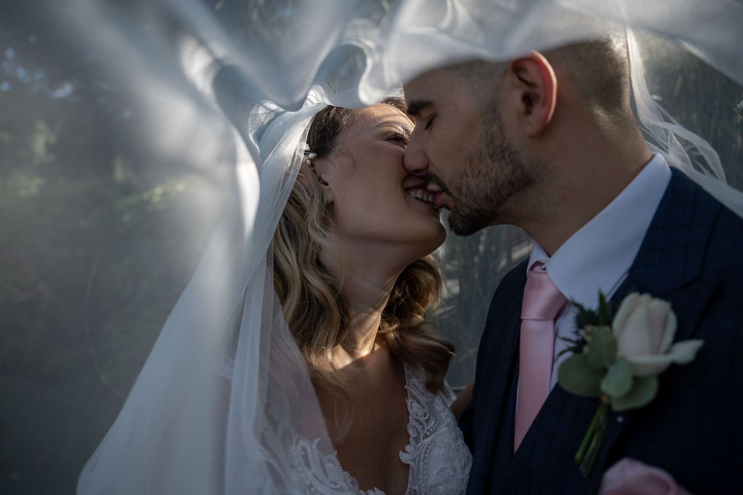 Bride and Groom share a kiss, under a lace veil - Gavin Horrell Photography, South West England