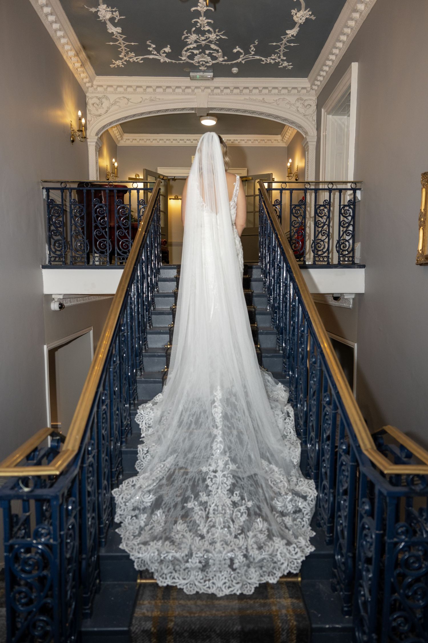 Long wedding dress train, descending down a staircase - Gavin Horrell Photography