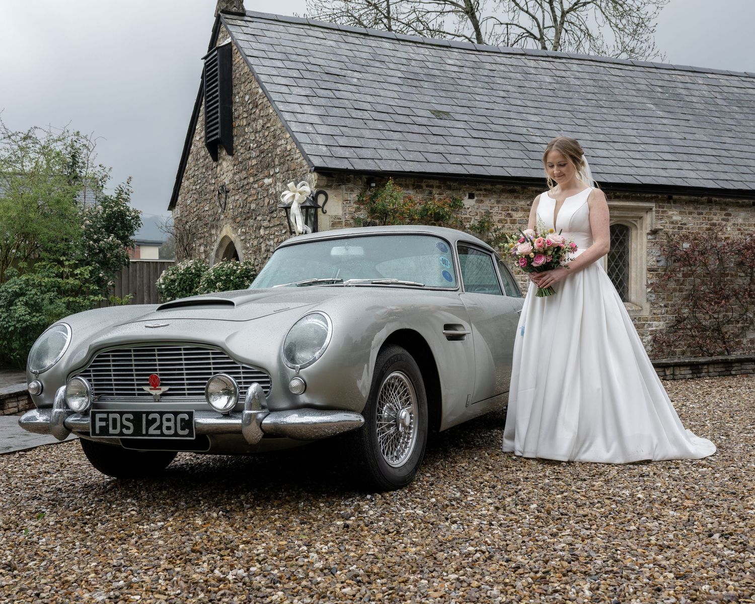 Bride and her bouquet, stood beside an Aston Martin DB5 - Gavin Horrell Photography