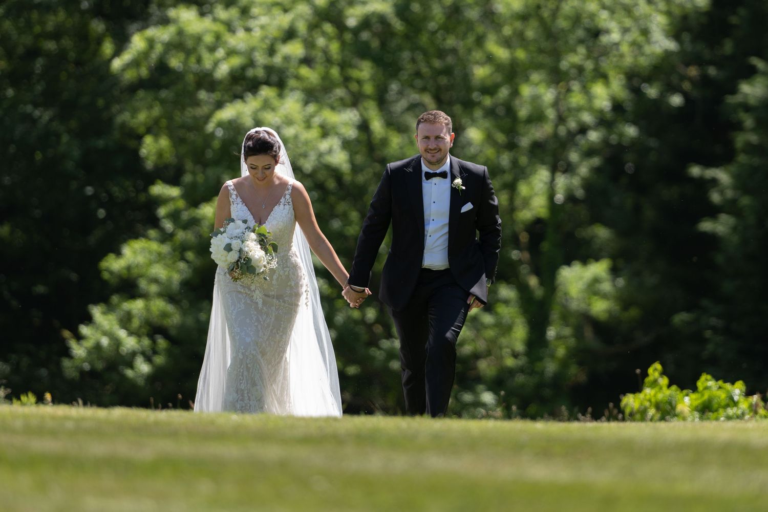 Wedding couple holding hands as they take a stroll - Gavin Horrell Photography