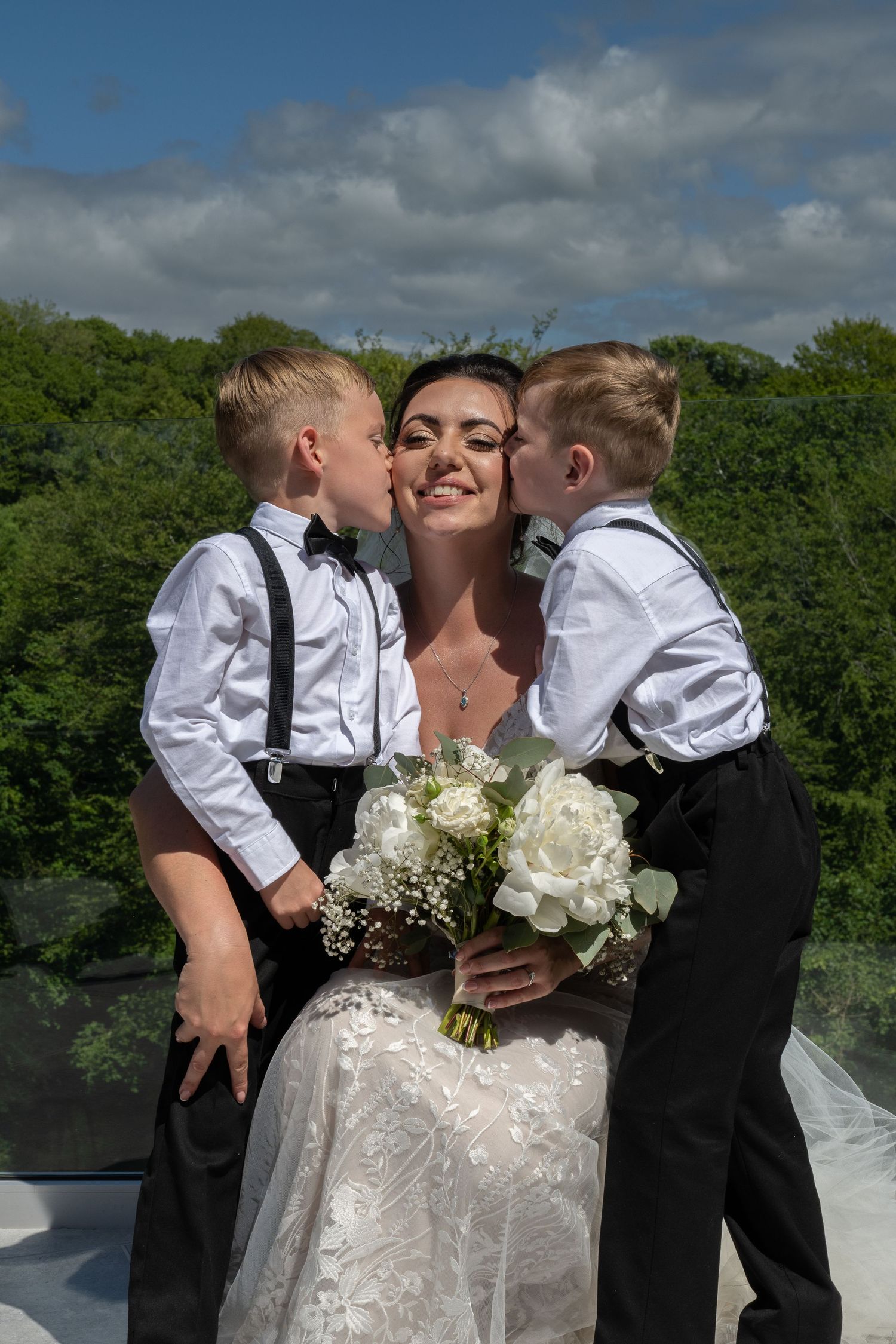 Wedding Bride being kissed by two young page boys - Gavin Horrell Photography