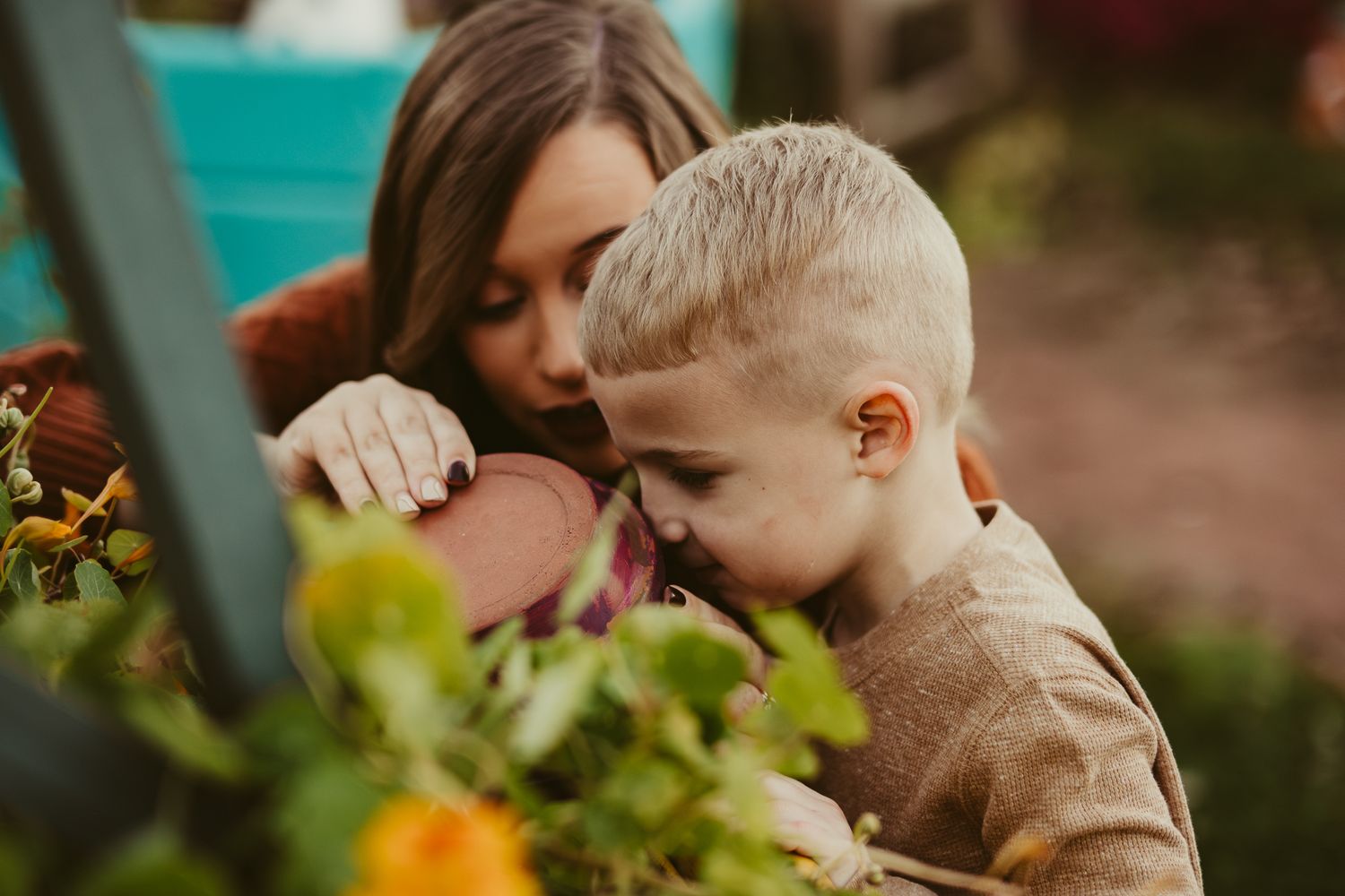 Close-up of shared discovery moment while exploring garden together.
