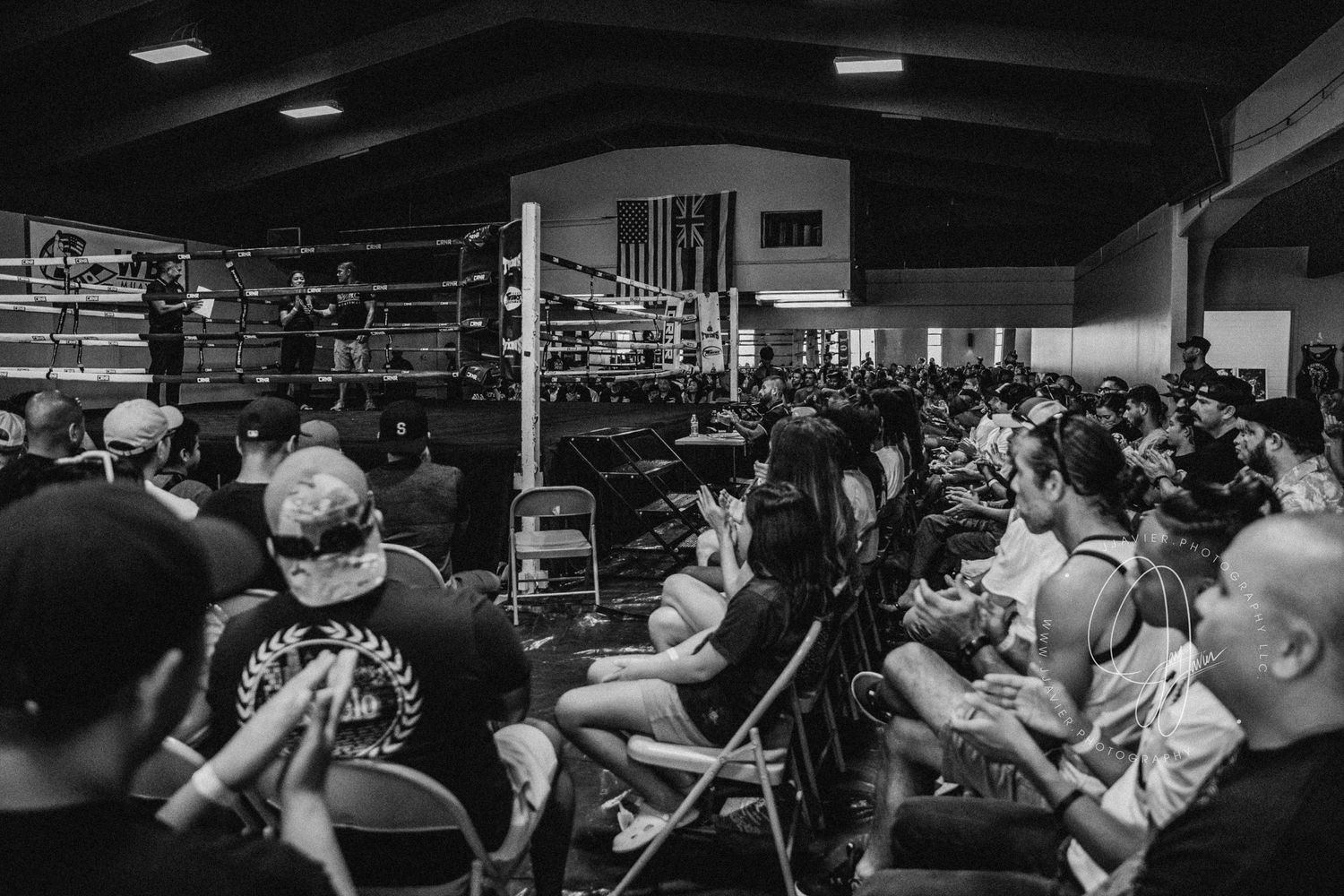 A dark indoor arena or venue with stadium lighting visible from above.