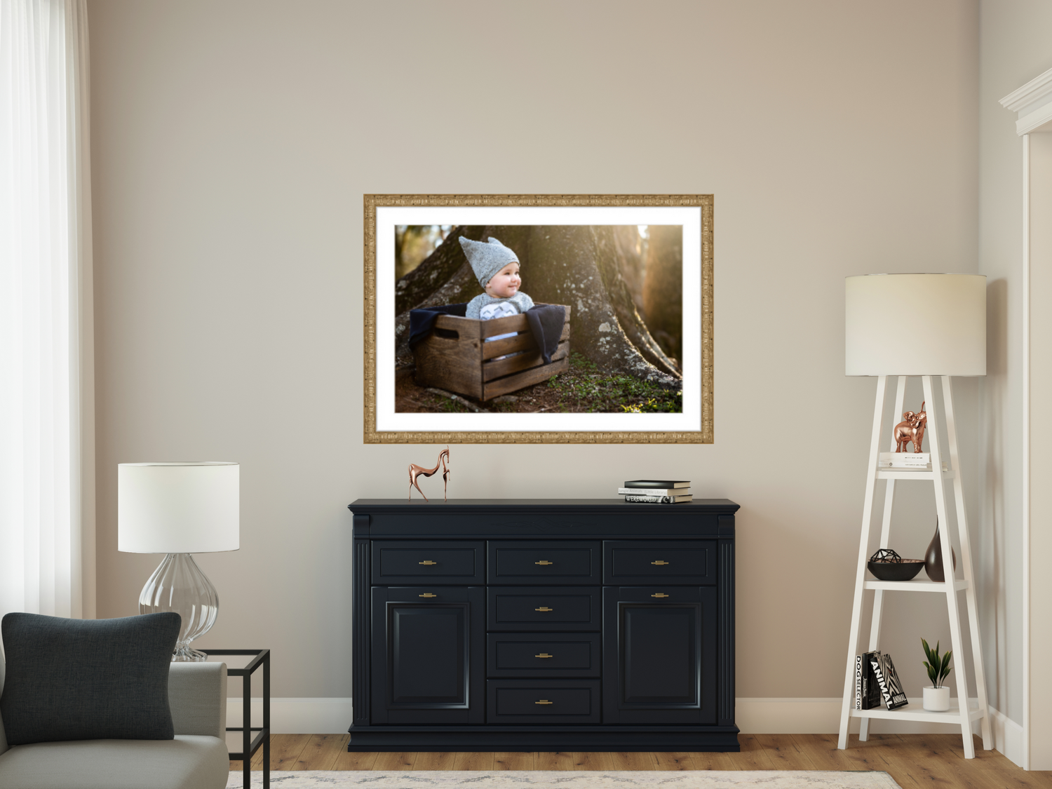 large wall portrait of toddler in Tuturo outfit sitting in crate at the base of a tree with sunlight glowing from side