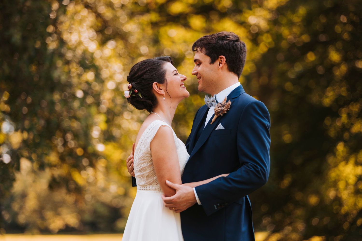 An intimate moment between newlyweds during their autumn wedding photoshoot.
