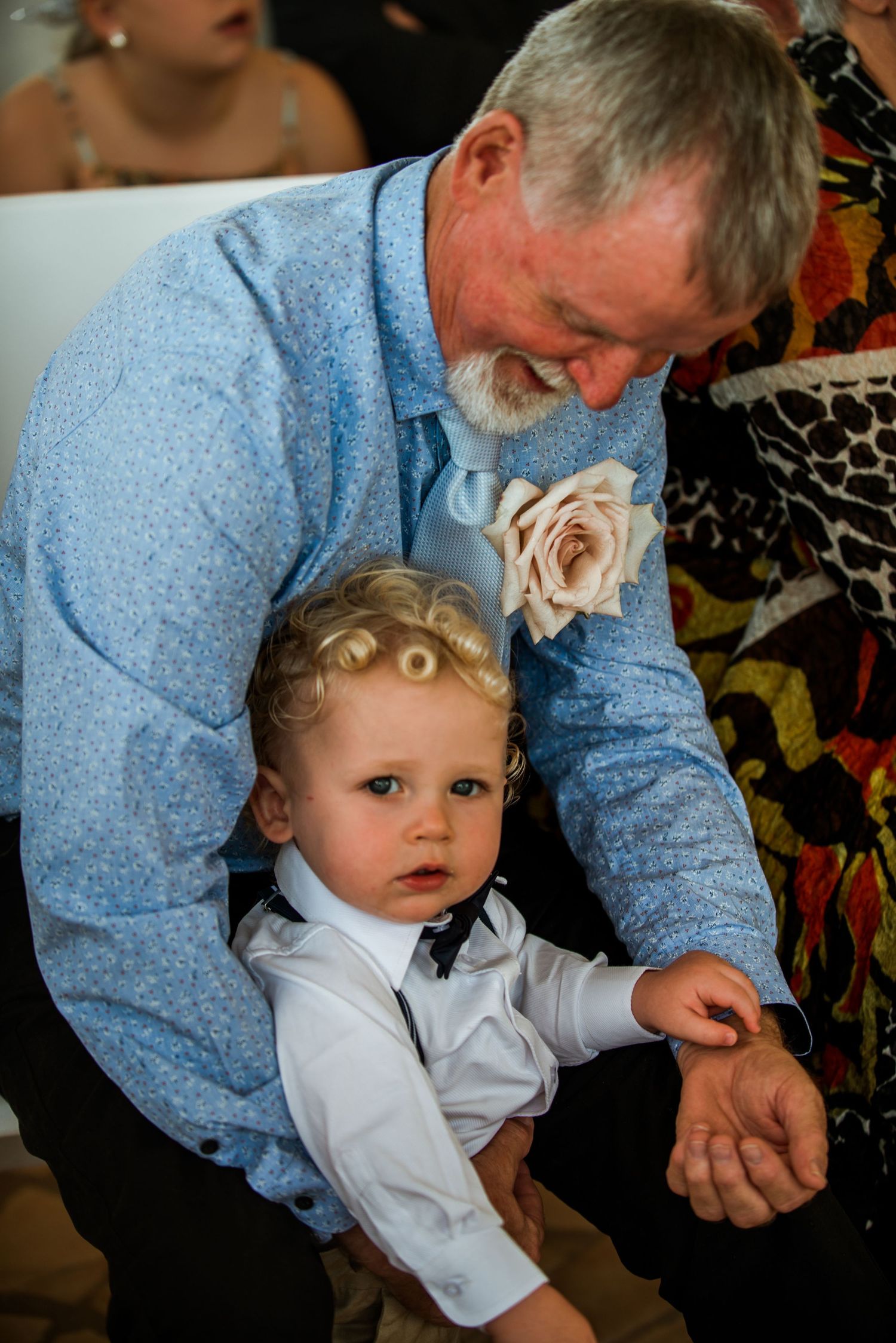 Tender moment shared between generations during wedding celebration.