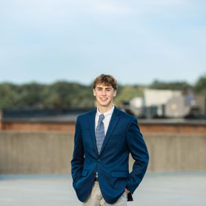 senior boy in suite and tie on parking deck