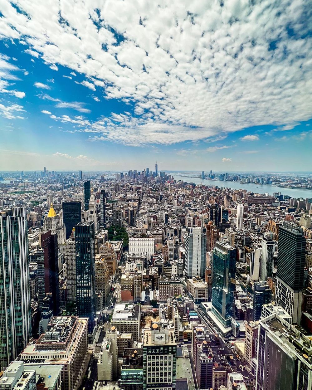Aerial view of Manhattan skyline under dramatic altocumulus clouds.