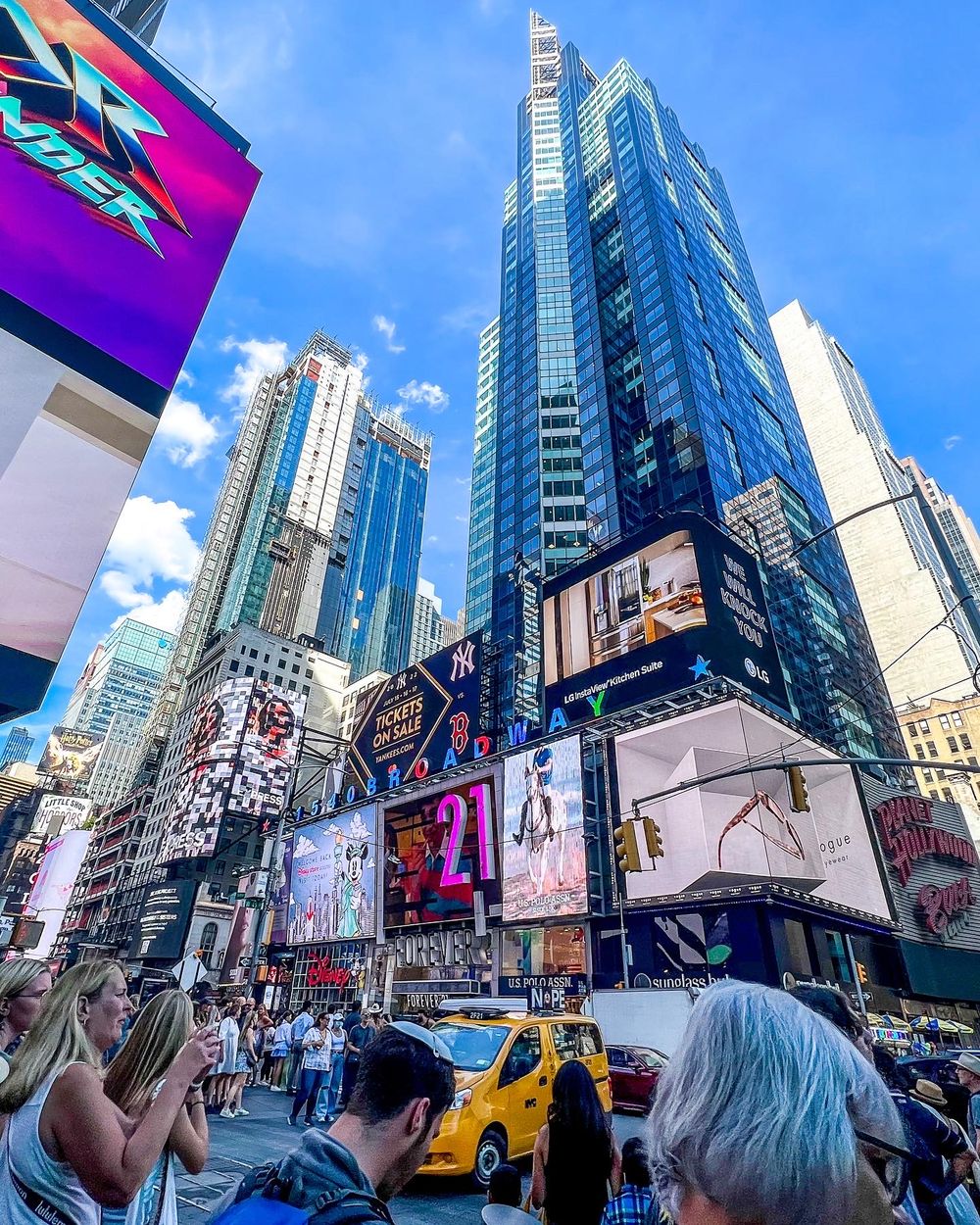 Times Square's vibrant billboards and skyscrapers tower above busy New York City streets.