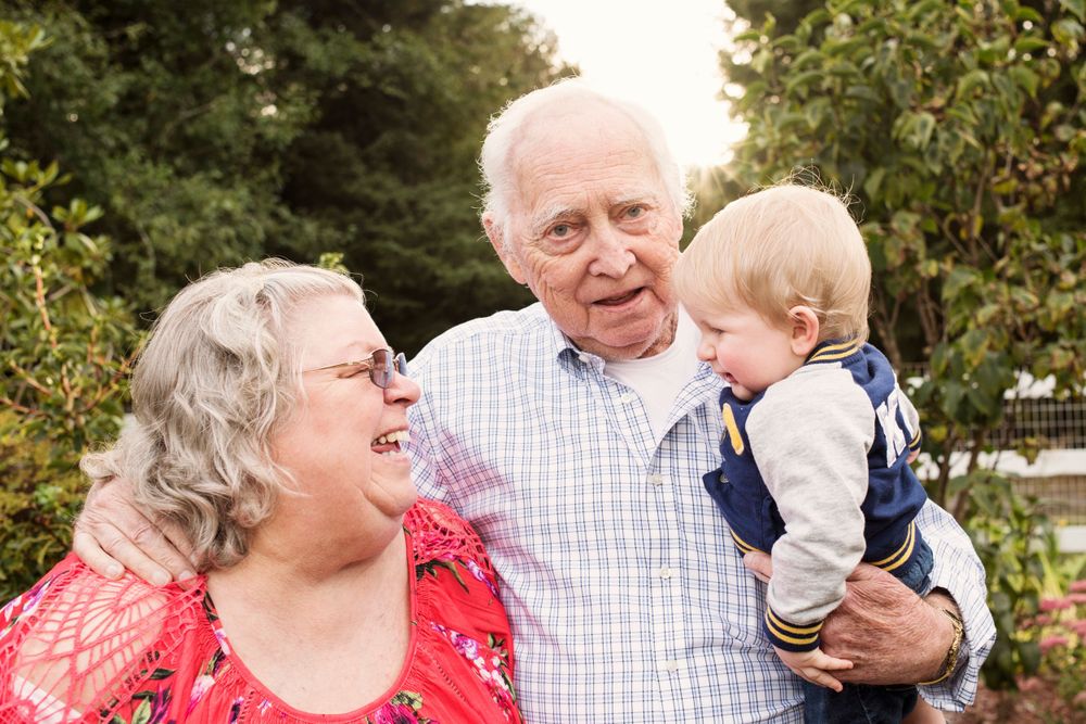 grandparents holding grandchild