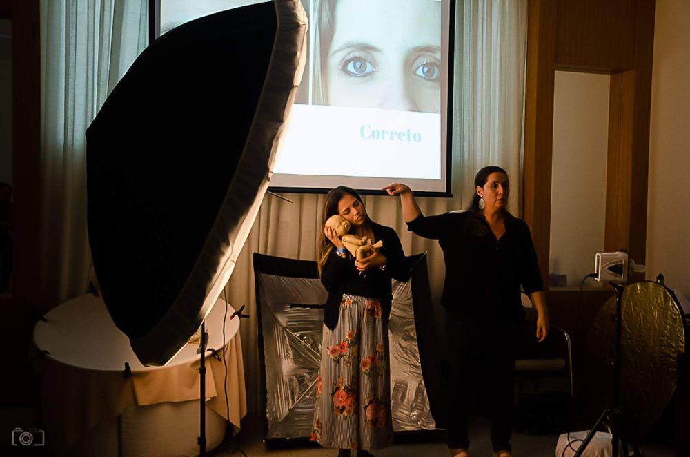 Behind-the-scenes photo studio setup with large softbox light and projected image.