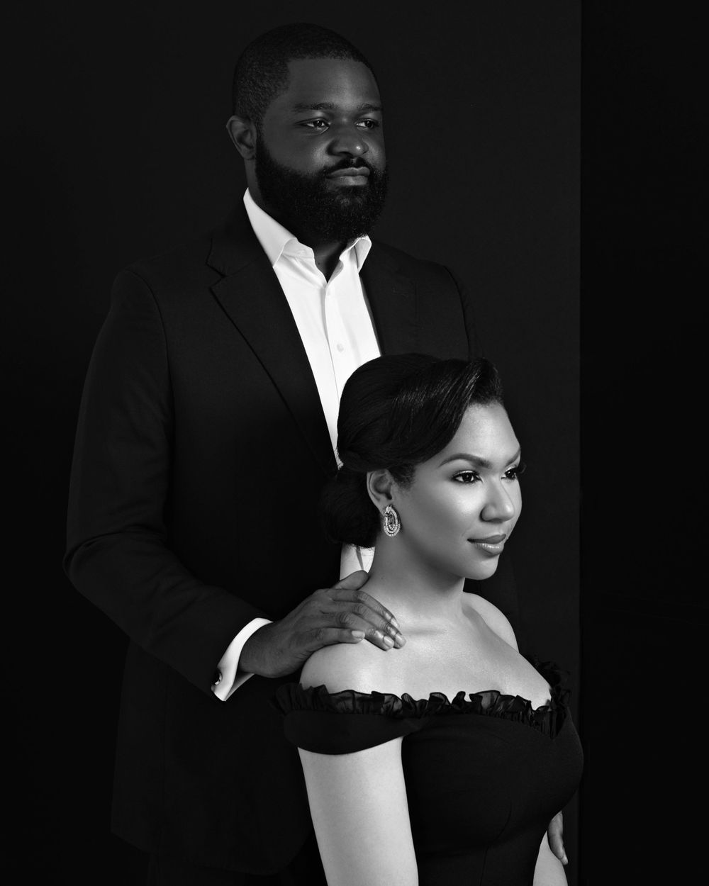 Elegant black and white portrait of couple in formal attire.