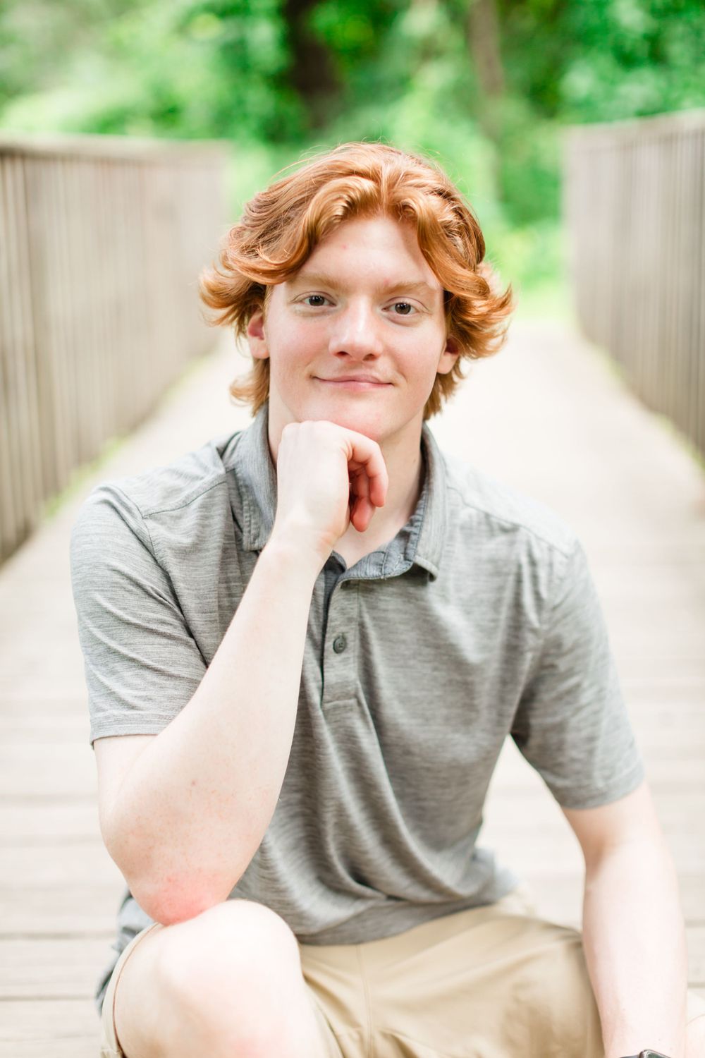 Portrait on wooden bridge with soft natural lighting.
